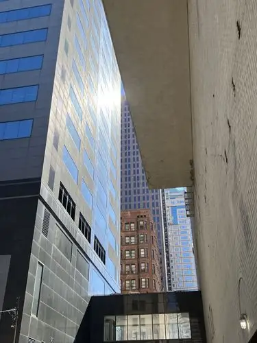 Sunlight slices through the urban canyon.